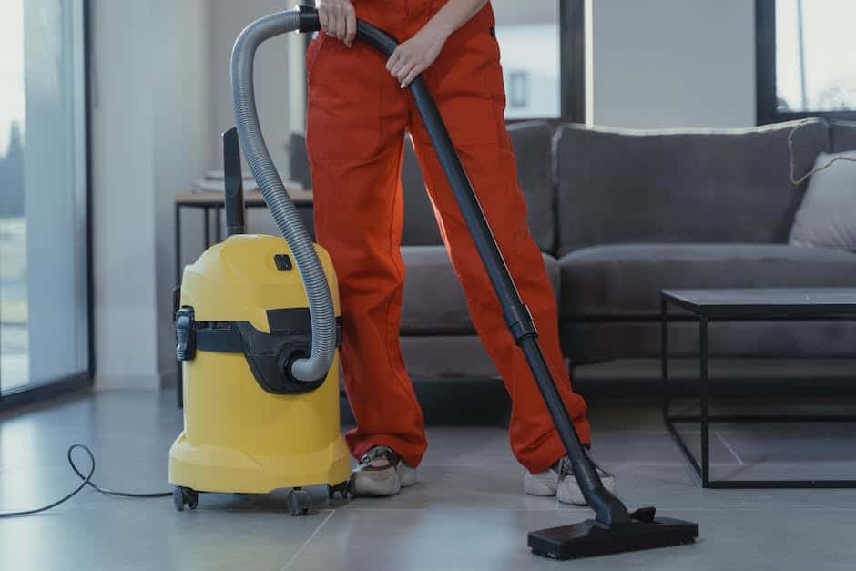 An image depicting a person using a vacuum cleaner and cleaning supplies to clean an office space.